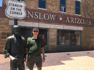 Paul Gagliano in standing on the corner in Winslow Arizona with his friend